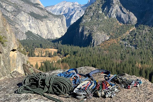 Yosemite National Park rock climbing anchoring gear with view of vally